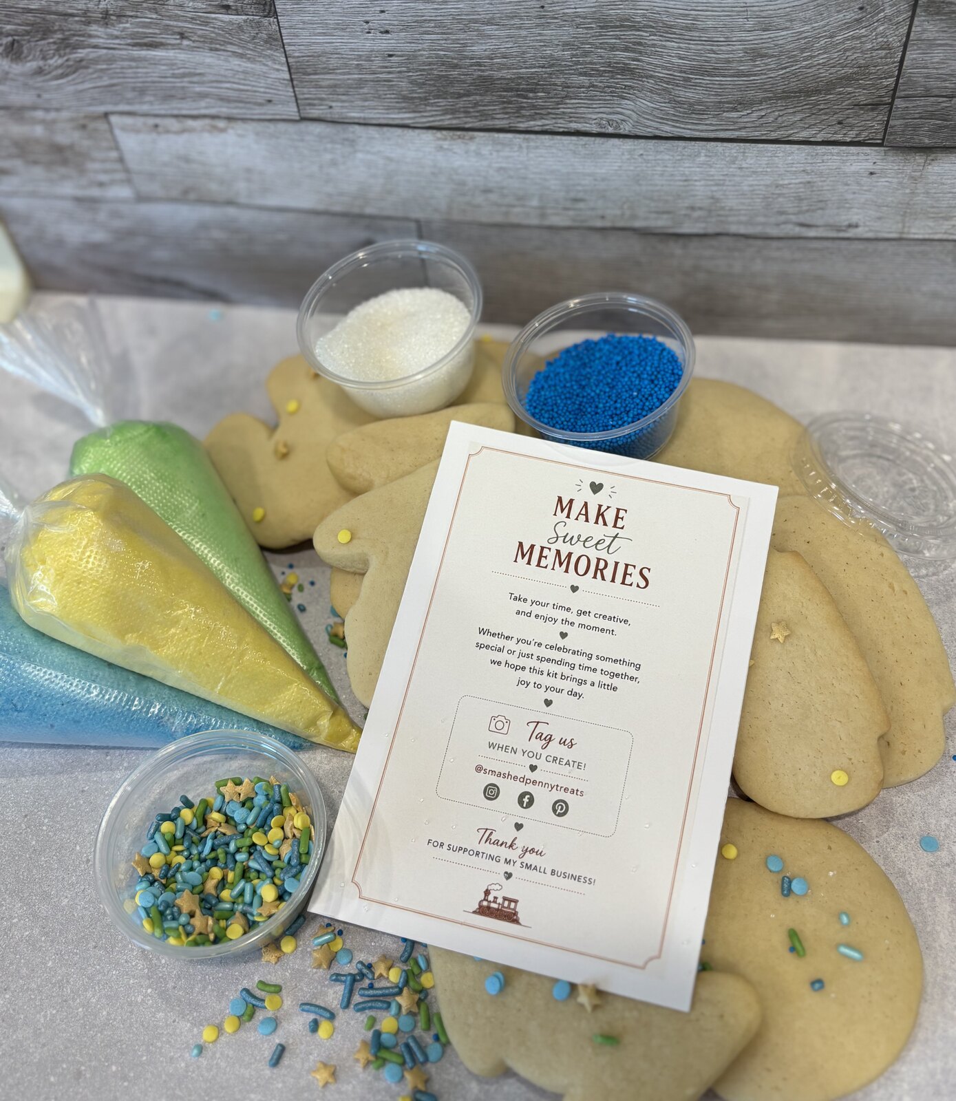 Fresh-baked sugar cookies with buttercream piping bags and sprinkles